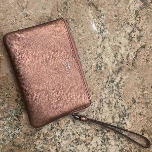 Coach bronze colored wristlet never used! Two card slots inside.